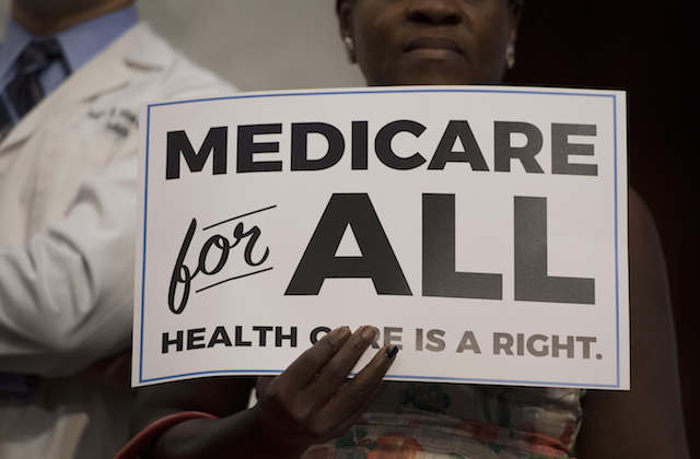 black and white sign that reads "Medicare for all"