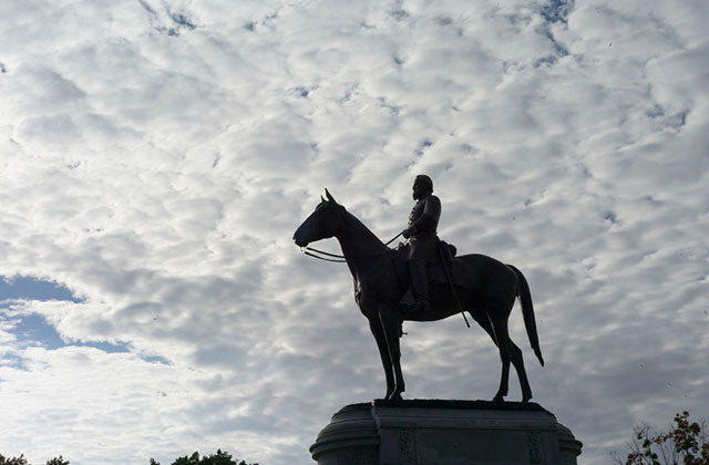 Confederate. A  soldier on a horse with heavy clouds in background.