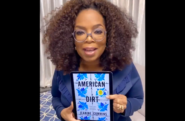 Oprah Winfrey. Black woman with shoulder length brown hair wearing glasses and blue top holding an electric reader showing "American Dirt" book cover.