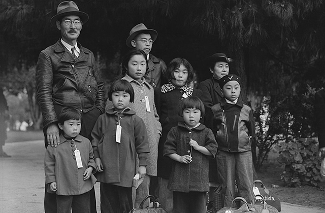 Japanese American family. A large family, including seven children in various ages, huddled wearing name tags.