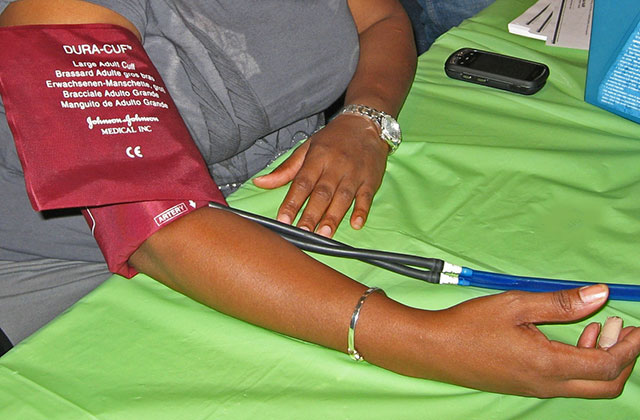 Blood pressure. Arm of Black person getting blood pressure taken.