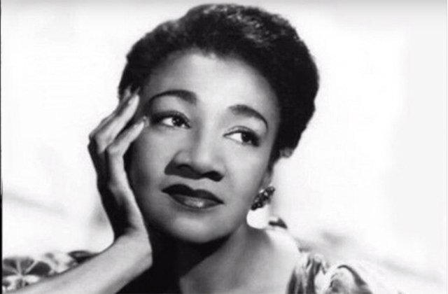Alberta Hunter. Black and white photo of Black woman with chin in hand.