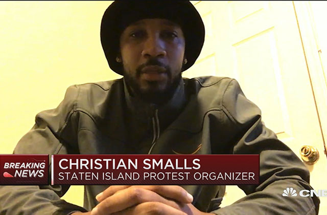 Chris Smalls. Black man with dark facial hair wearing dark hat and khaki shirt.