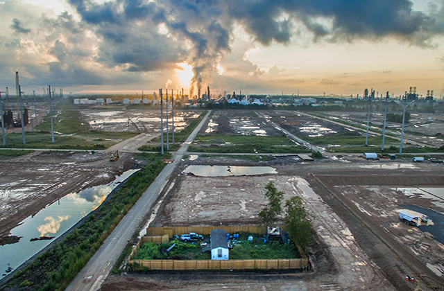 Mossville, Louisiana. Trailer standing alone in the middle of dug up ground for miles.