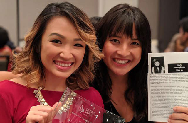 Wake Up Atlanta. Two Vietnamese American women, one with shoulder-length blonde hair wearing a red top and the other with longer dark hair.