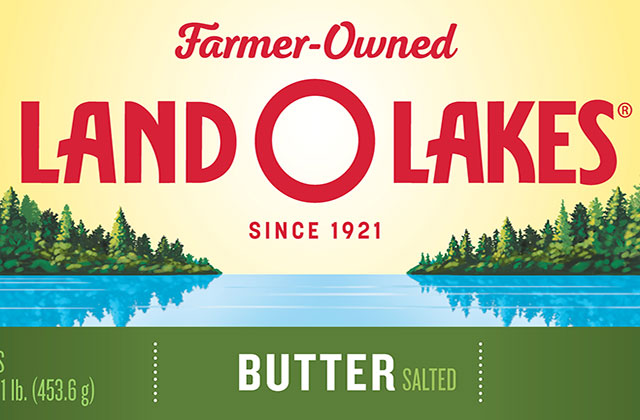 Land-O-Lakes. Packaging for butter that has yellow background with green trees alongside a blue lake.