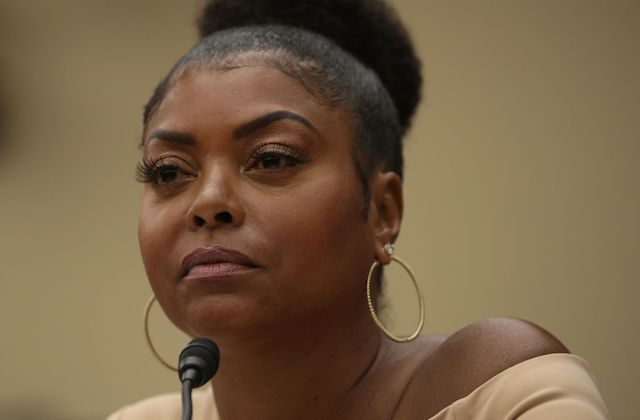 Close-up photo of actress Taraji P. Henson sitting in front of a black microphone