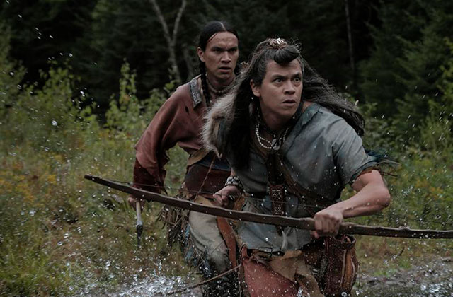 Barkskins. Film scene of two Indigenous men crossing a creek.