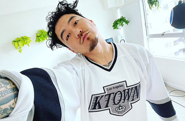 Dumbfoundead. Asian-American man with dark hair wearing K Town white and black jersey.