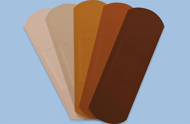 Band Aid. Five bandage strips ranging in color from light tan to dark brown.