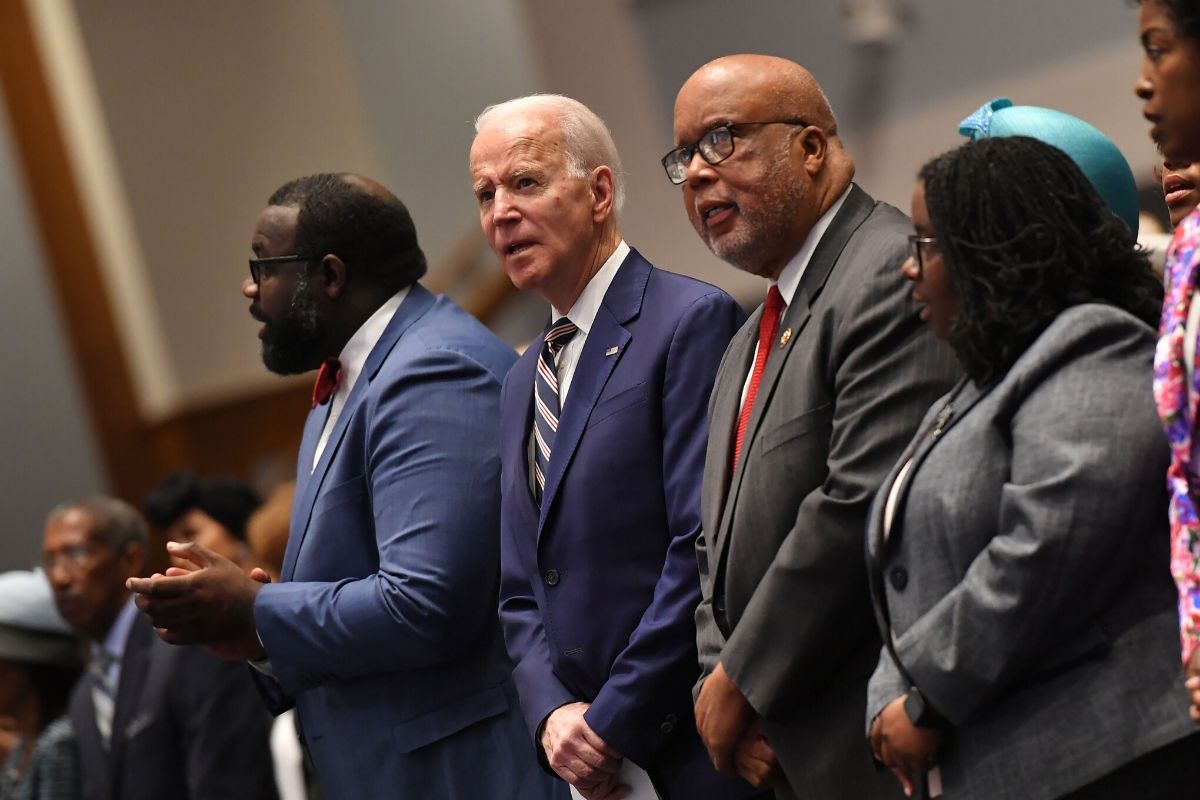Four people standing in church, three African Americans and one Caucasian man in suit, Democratic presidential candidate Joe Biden