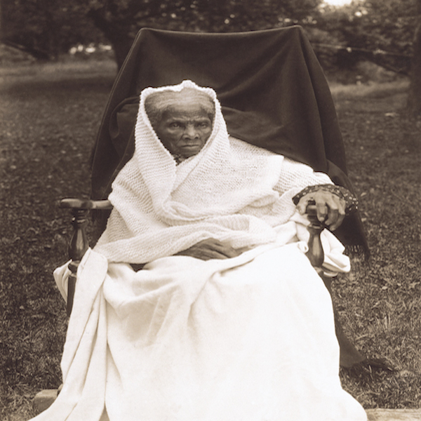 Harriet Tubman is sitting on a chair outside of her home in New York in 1911.