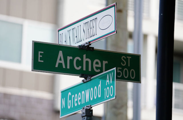 Tulsa street signs that read Black Walk Street, Archer and Greenwood