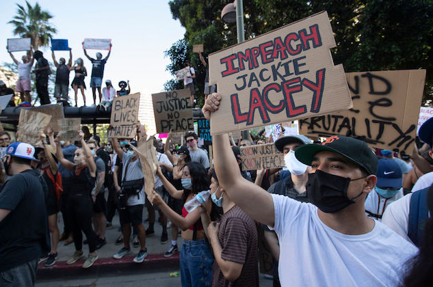 Protester holds a sign that reads, Impeach Jackie Lacey