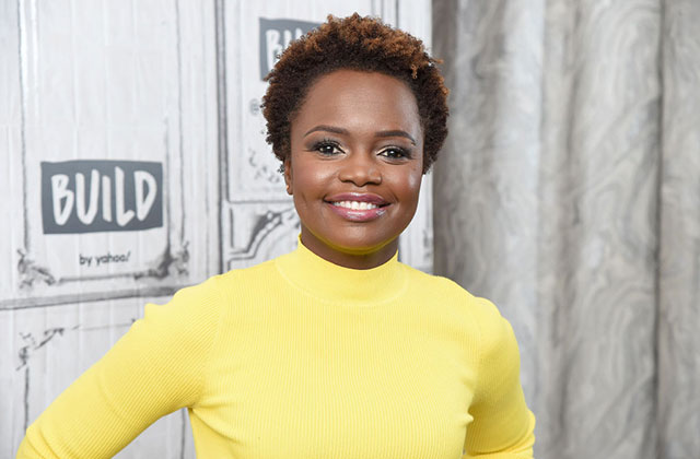 Karine-Jean-Pierre. Black woman with short brown hair wearing a yellow top.