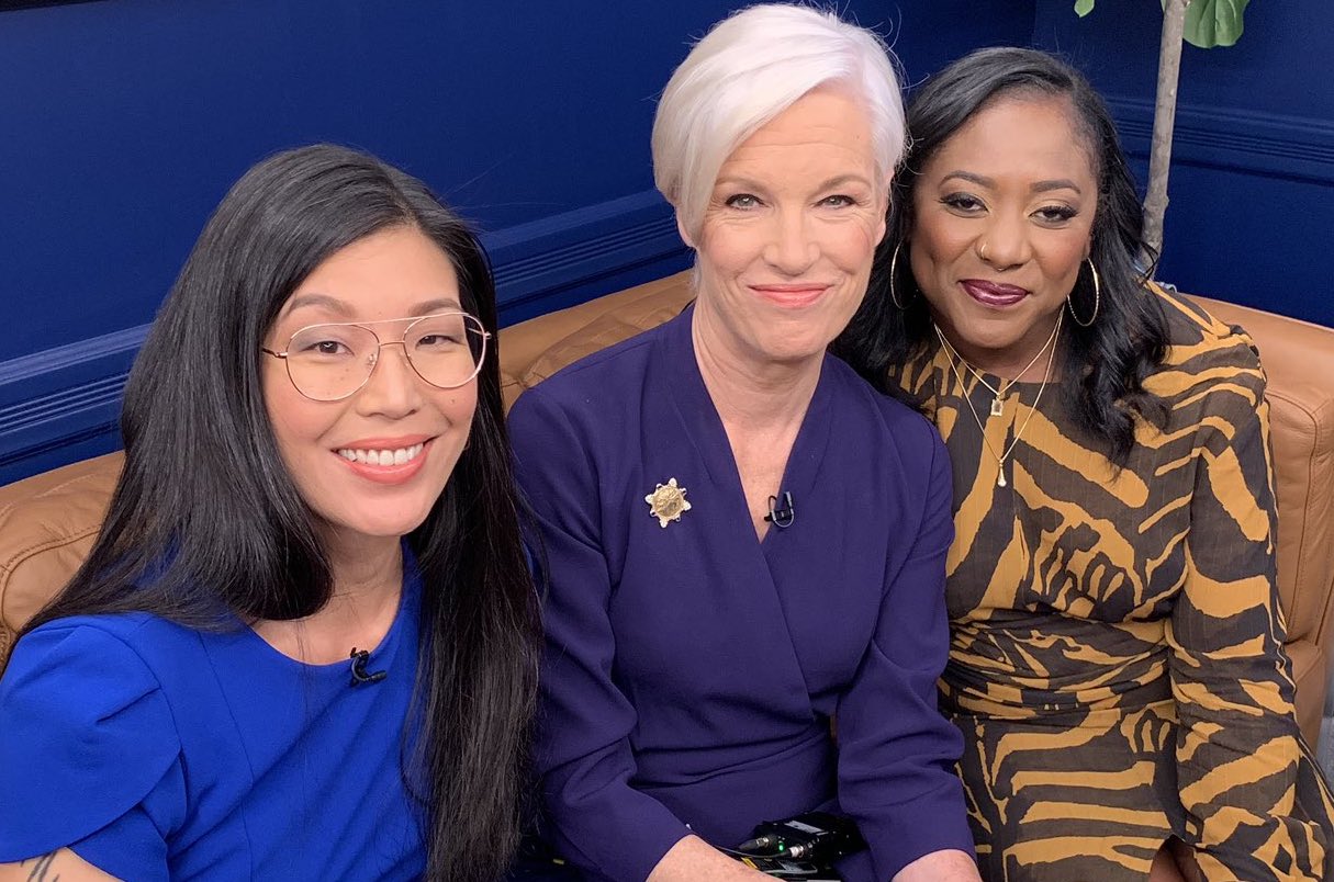 A trio of powerful Asian, white, and Black woman leaders pose on couch