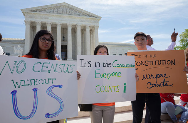 Census demonstration. Three people hold handmade signs demanding to be counted in the Census.