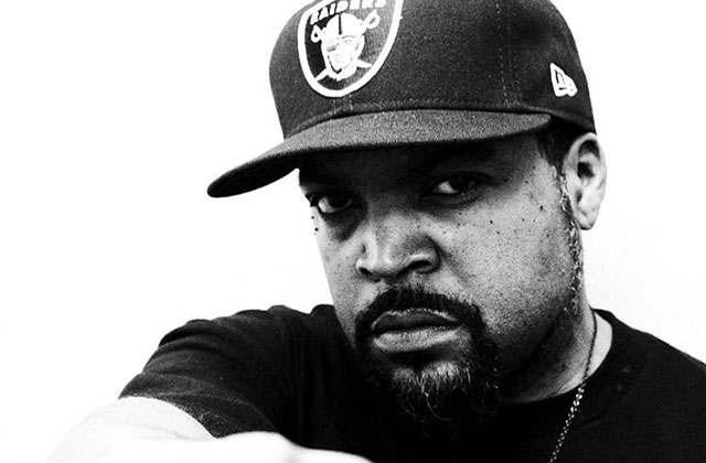 Ice Cube.Black man wearing a black Raiders baseball cap and black shirt.