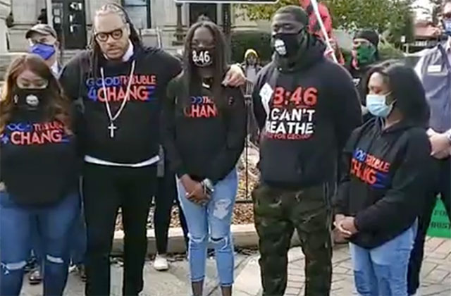 I-AM-THE-CHANGE-MARCH. Two Black men and three women wearing black shirts reading "I Am the Change" stand together.