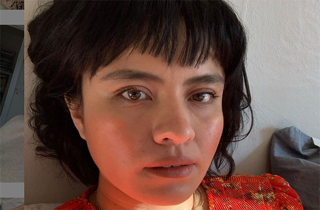 Karla Cornejo Villavicencio. Latinx woman with short dark hair wearing a red top.