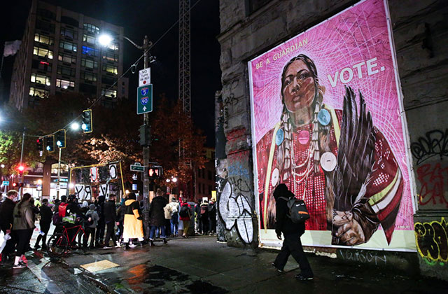 Native-American-Vote. Artwork on side of a building of Native American woman dressed in traditional attire.