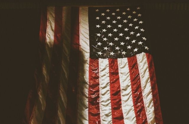 A wet American flag is hung vertically