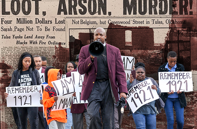 Dr. Robert Turner leads a group from the Vernon African Methodist Episcopal (AME) church to Tulsa City Hall, demanding “reparations now.”