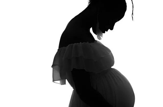 Silhouette of a pregnant woman.