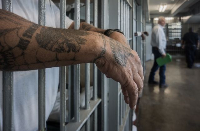 A prisoner's hands inside a punishment cell wing at Angola prison. The Louisiana State Penitentiary, also known as Angola, is nicknamed the "Alcatraz of the South" and "The Farm".