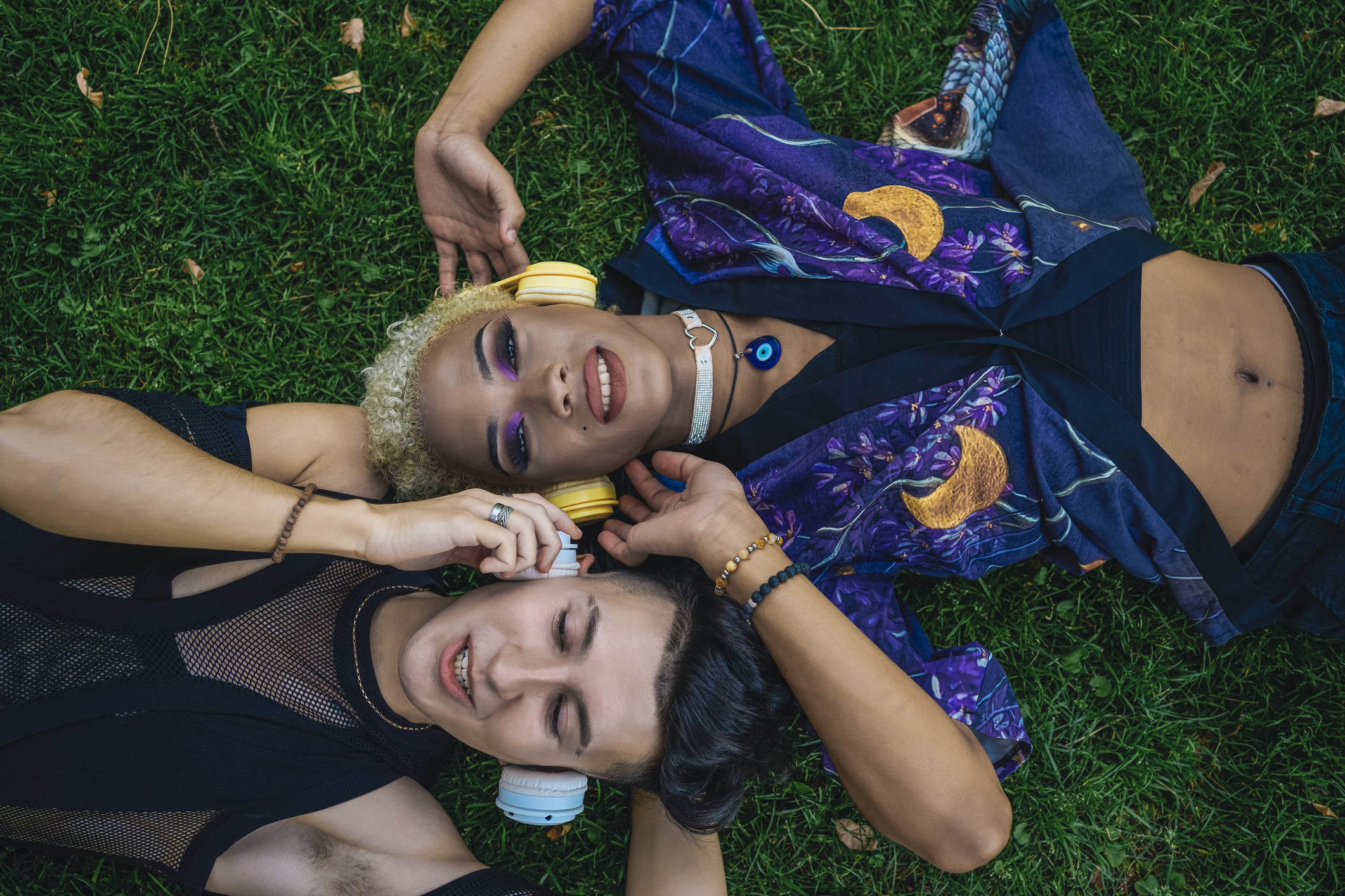 Young couple relaxing on grass together, overhead view