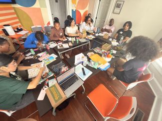 A group of youth and adult facilitators in a zine workshop