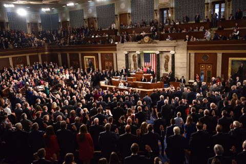 House of Representatives. Shot of the room from above that is crowded with people wearing suits.