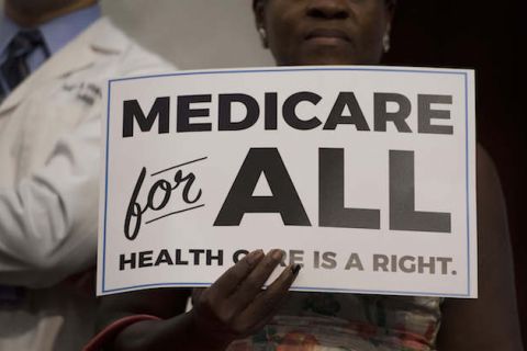 black and white sign that reads "Medicare for all"