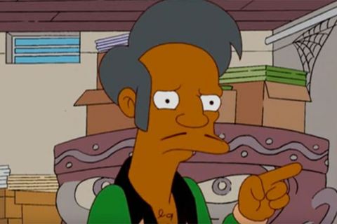 Apu Nahasapeemapetilon. Cartoon of South Asian male with gray hair, thin mustache, wearing green shirt with black collar. 