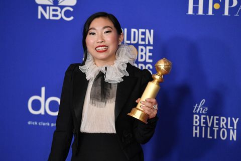 Awkwafina. Asian-American woman with dark hair wearing white and black dress.
