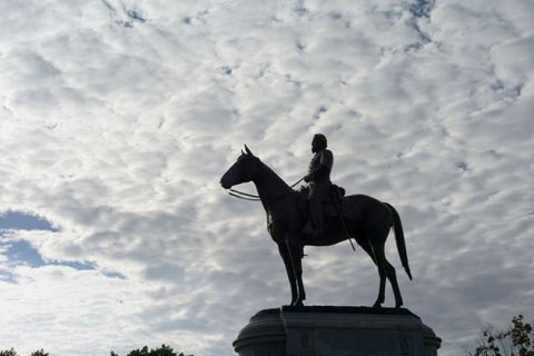 Confederate. A  soldier on a horse with heavy clouds in background.