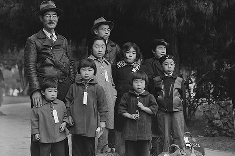 Japanese American family. A large family, including seven children in various ages, huddled wearing name tags.