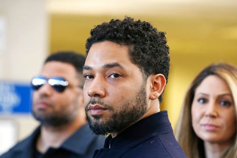 Jussie Smollett. Black man with short mustache and beard and short dark curly hair wearing dark suit jacket.