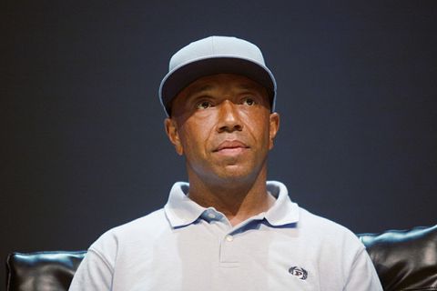 Russell Simmons. Black man wearing light gray baseball hat and light gray shirt.