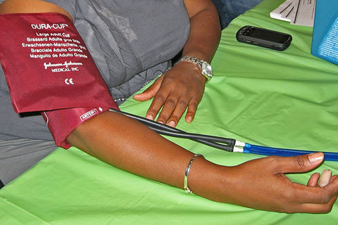 Blood pressure. Arm of Black person getting blood pressure taken.