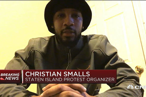 Chris Smalls. Black man with dark facial hair wearing dark hat and khaki shirt.