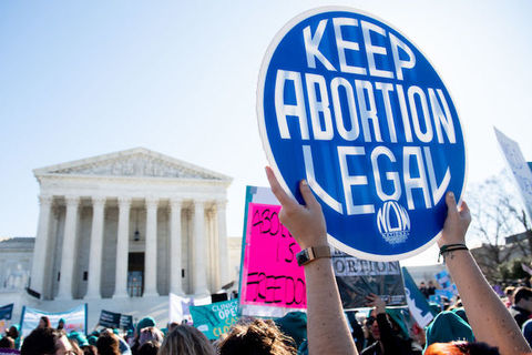 Protestor in front of the U.S. Supreme Court holds a sign that reads, "keep abortion legal" 