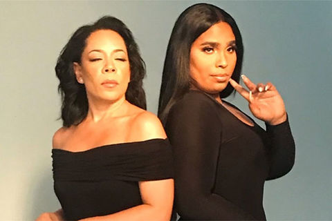 Selenis and Marizol Leyva. Two Latinx women standing side-by-side. They both have long dark hair wearing black dresses.