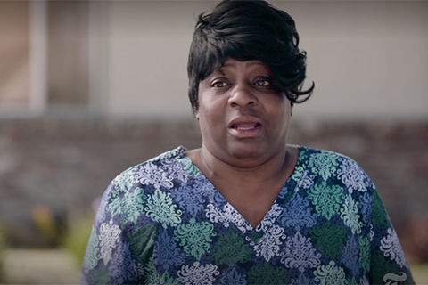 Verna White. Black woman with short dark hair wearing colorful top with flowers.