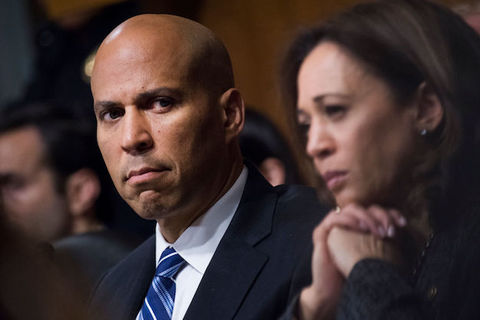 close-up of serious looking senators Cory Booker and Kamala Harris.