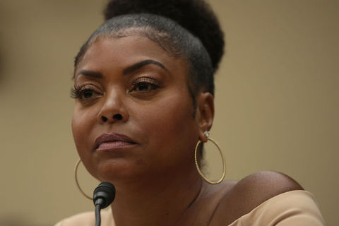 Close-up photo of actress Taraji P. Henson sitting in front of a black microphone
