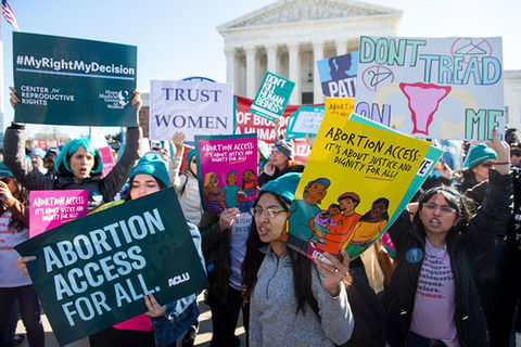 Abortion rally. A group of young women holding signs for increased abortion access outside the Supreme Court.