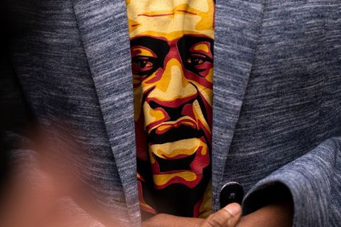 Martyr George Floyd on a T-shirt, peeking out of a person's slightly open jacket. 