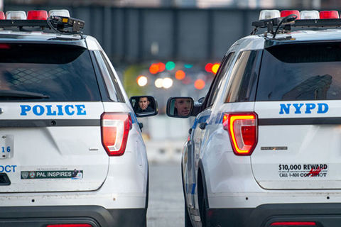 Police cars. Two NYPD cars from the rear.