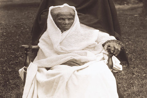 Harriet Tubman is sitting on a chair outside of her home in New York in 1911.